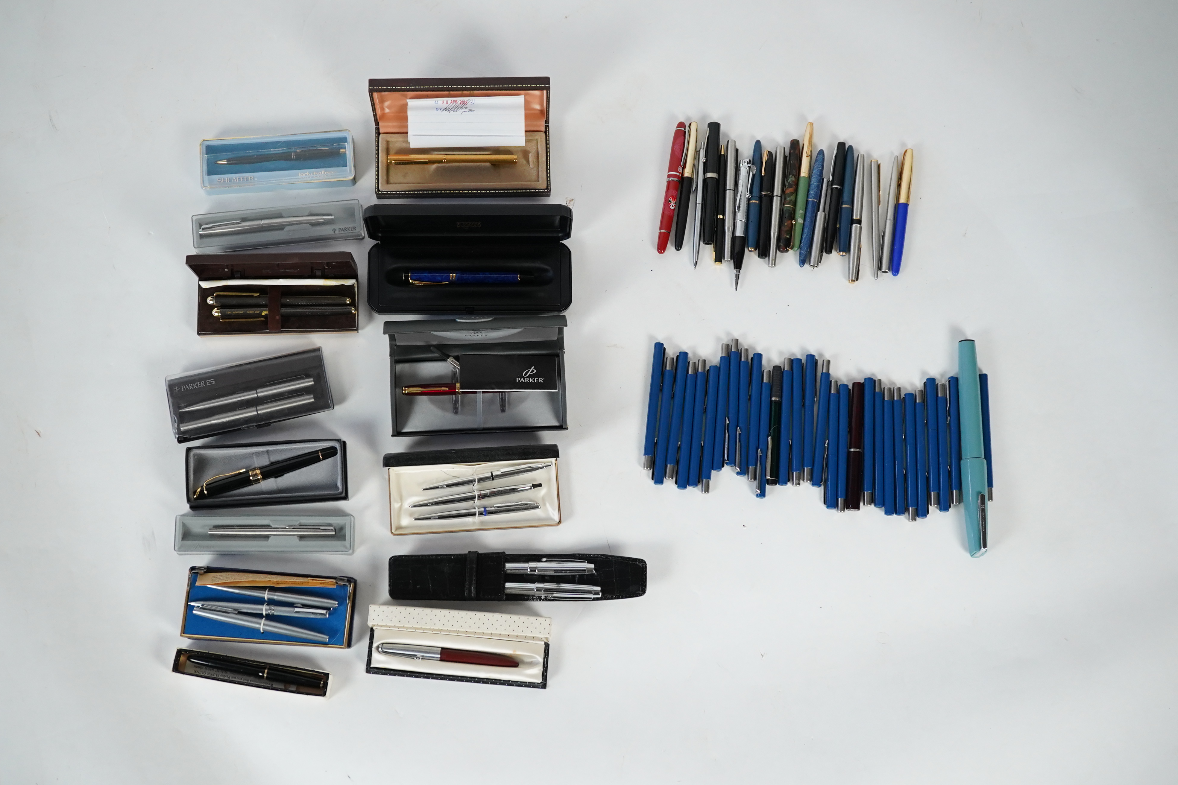 A cased Parker duofold ballpoint pen, a cased Parker Sonnet lacquer ruby red fountain pen, a Dunhill gold plated fountain pen and various fountain pens and ballpoint pens including Parker, Sheaffer, Quill, etc.